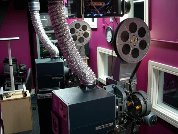 Twin 35mm motion picture cinema projectors in projection booth