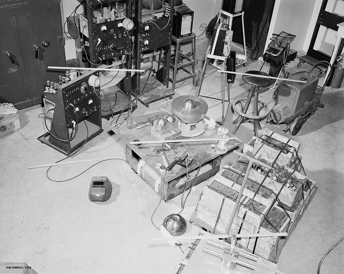 Mockup of the Louis Slotin criticality experiment showing beryllium hemisphere and screwdriver